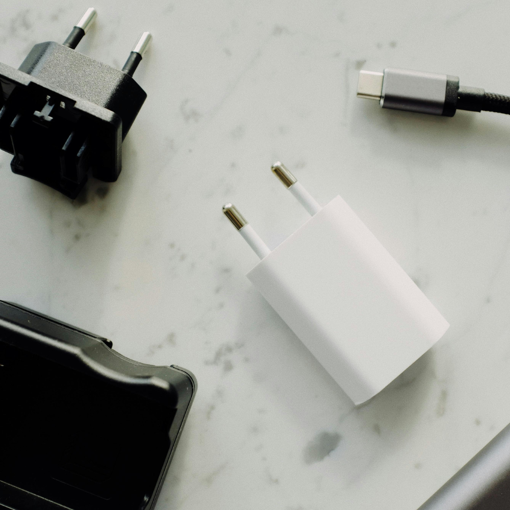 Non-surge power strip on small desk with charging cables